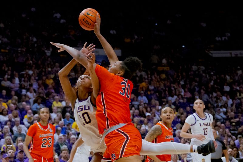 Feb 22, 2024; Baton Rouge, Louisiana, USA;  LSU Lady Tigers forward Angel Reese (10) has her shot blocked by Auburn Tigers center Savannah Scott (30) during the first half at Pete Maravich Assembly Center. Mandatory Credit: Matthew Hinton-USA TODAY Sports