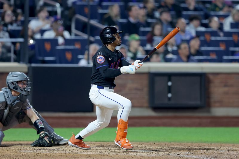 May 30, 2025; New York City, New York, USA; New York Mets shortstop Francisco Lindor (12) follows through on a solo home run against the Colorado Rockies during the eighth inning at Citi Field. Mandatory Credit: Brad Penner-Imagn Images
