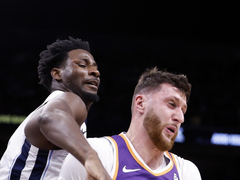 PHOENIX, ARIZONA - JANUARY 07: Jusuf Nurkic #20 of the Phoenix Suns controls a rebound in front of Jaren Jackson Jr. #13 of the Memphis Grizzlies during the first half at Footprint Center on January 07, 2024 in Phoenix, Arizona. NOTE TO USER: User expressly acknowledges and agrees that, by downloading and or using this photograph, User is consenting to the terms and conditions of the Getty Images License Agreement.  (Photo by Chris Coduto/Getty Images)