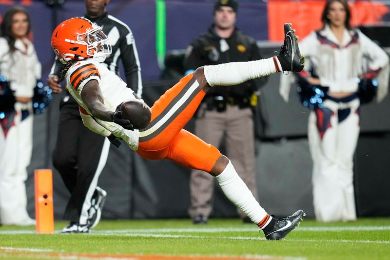 Cleveland Browns wide receiver Jerry Jeudy falls backwards into the endzone after a 70-yard pass reception to score during the second half of an NFL football game against the Denver Broncos, Monday, Dec. 2, 2024, in Denver. (AP Photo/Jack Dempsey)