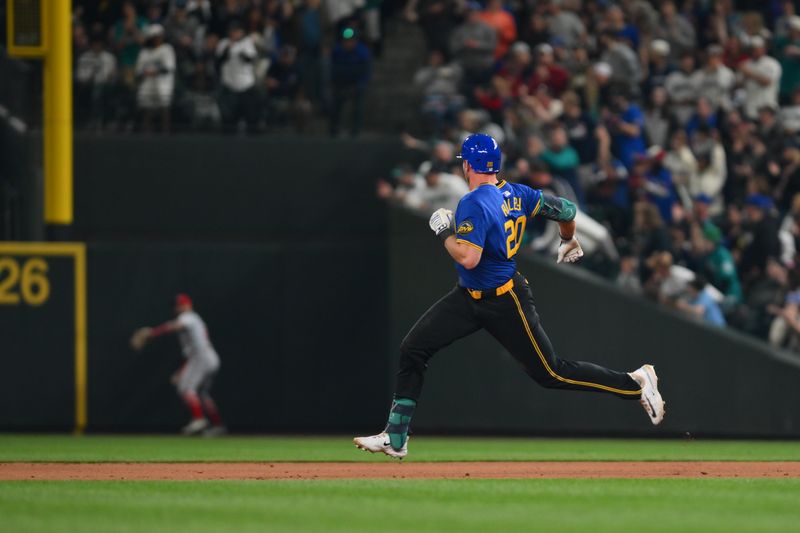 May 31, 2024; Seattle, Washington, USA; Seattle Mariners left fielder Luke Raley (20) looks towards right field after hitting a double against the Los Angeles Angels during the eighth inning at T-Mobile Park. Mandatory Credit: Steven Bisig-USA TODAY Sports