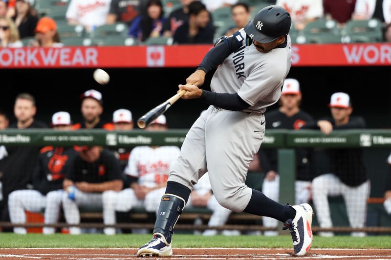 Apr 29, 2025; Baltimore, Maryland, USA; New York Yankees outfielder Trent Grisham (12) hits a home run during the first inning against the Baltimore Orioles at Oriole Park at Camden Yards. Mandatory Credit: Daniel Kucin Jr.-Imagn Images