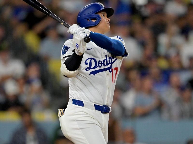 Sep 17, 2025; Los Angeles, California, USA;  Los Angeles Dodgers designated hitter Shohei Ohtani (17) hits his 51st home run of the season in the eighth inning against the Philadelphia Phillies at Dodger Stadium. Mandatory Credit: Jayne Kamin-Oncea-Imagn Images