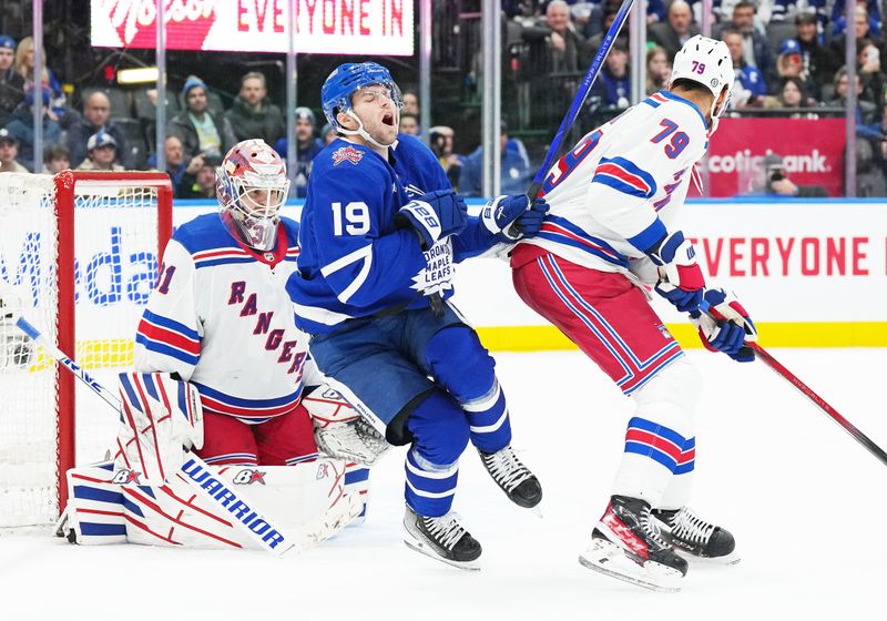 Dec 19, 2023; Toronto, Ontario, CAN; Toronto Maple Leafs center Calle Jarnkrok (19) gets hit with the puck batting with New York Rangers defenseman K'Andre Miller (79) in front of  goaltender Igor Shesterkin (31) during the third period at Scotiabank Arena. Mandatory Credit: Nick Turchiaro-USA TODAY Sports