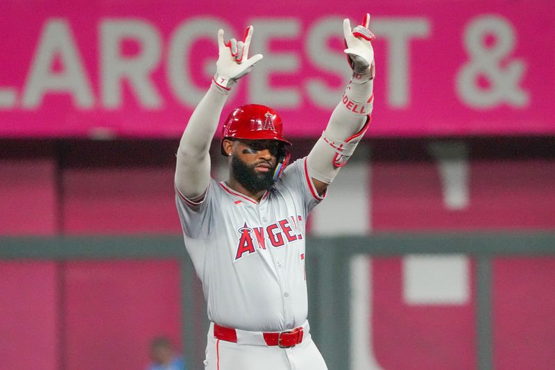 Aug 19, 2024; Kansas City, Missouri, USA; Los Angeles Angels right fielder Jo Adell (7) celebrates at second base after hitting a two-run double in the seventh inning against the Kansas City Royals at Kauffman Stadium. Mandatory Credit: Denny Medley-USA TODAY Sports