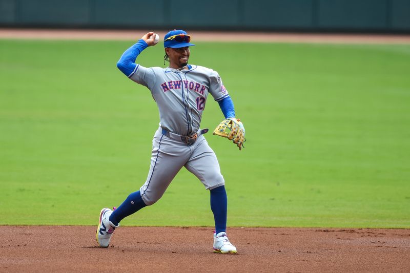 Sep 30, 2024; Atlanta, Georgia, USA; New York Mets shortstop Francisco Lindor (12) throws a runner out at first against the Atlanta Braves in the first inning at Truist Park. Mandatory Credit: Brett Davis-Imagn Images