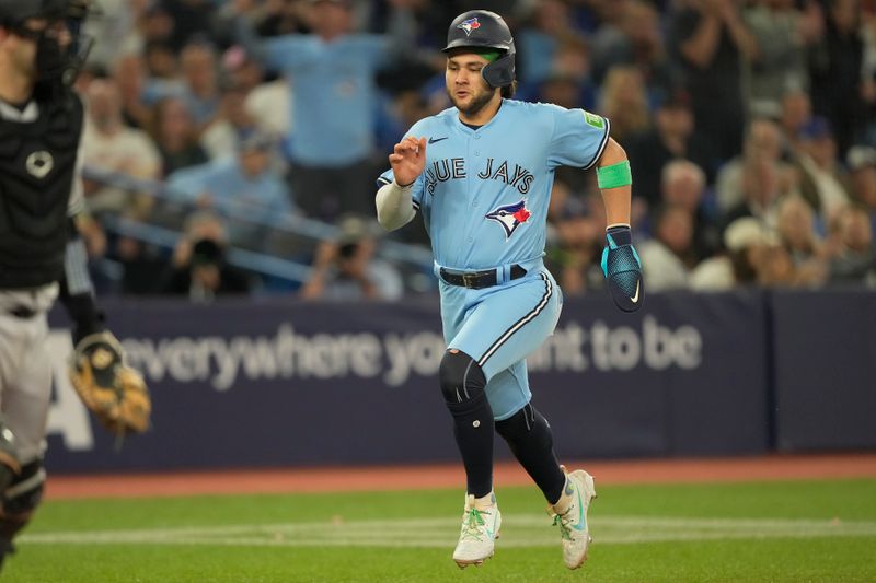 Sep 28, 2023; Toronto, Ontario, CAN; Toronto Blue Jays shortstop Bo Bichette (11) scores against the New York Yankees during the fifth inning at Rogers Centre. Mandatory Credit: John E. Sokolowski-USA TODAY Sports