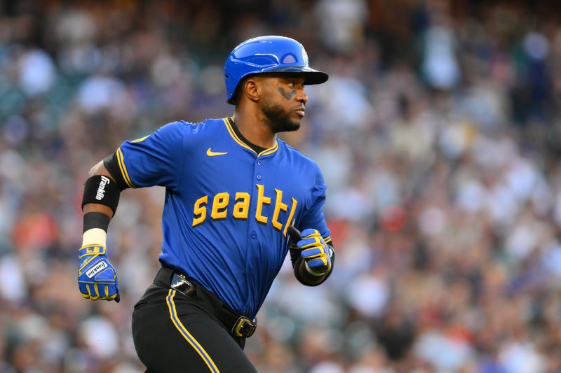 Jul 19, 2024; Seattle, Washington, USA; Seattle Mariners right fielder Victor Robles (10) runs towards first base after hitting a single against the Houston Astros during the third inning at T-Mobile Park. Mandatory Credit: Steven Bisig-USA TODAY Sports