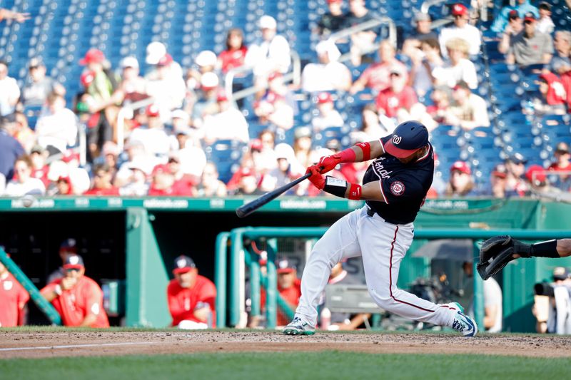 Jun 19, 2024; Washington, District of Columbia, USA; Washington Nationals catcher Keibert Ruiz (20) singles against the Arizona Diamondbacks during the seventh inning at Nationals Park. Mandatory Credit: Geoff Burke-USA TODAY Sports