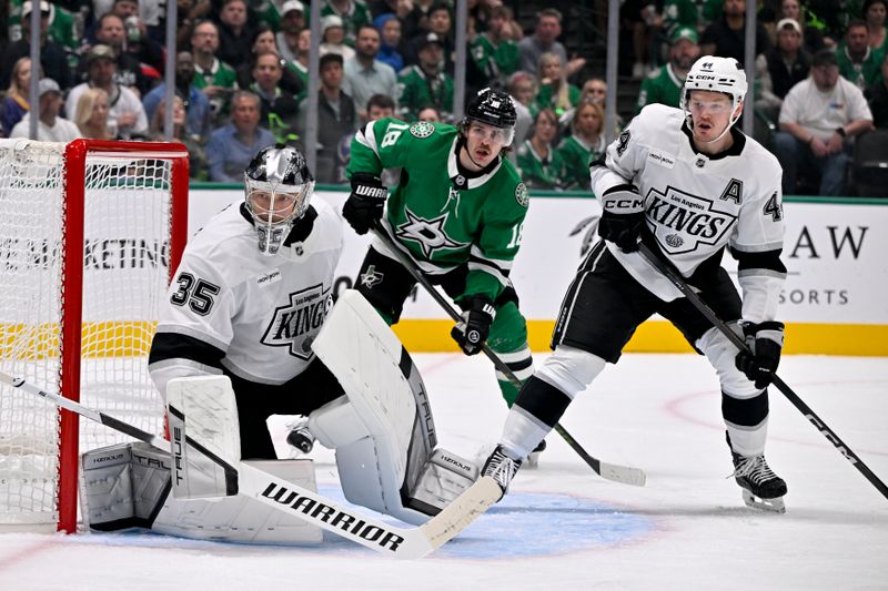 Oct 23, 2025; Dallas, Texas, USA; Los Angeles Kings goaltender Darcy Kuemper (35) and defenseman Mikey Anderson (44) and Dallas Stars center Sam Steel (18) look for the puck during the second period at the American Airlines Center. Mandatory Credit: Jerome Miron-Imagn Images
