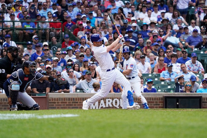 May 31, 2023; Chicago, Illinois, USA; Chicago Cubs first baseman Trey Mancini (36) hits a one-run single against the Tampa Bay Rays during the seventh inning
at Wrigley Field. Mandatory Credit: David Banks-USA TODAY Sports