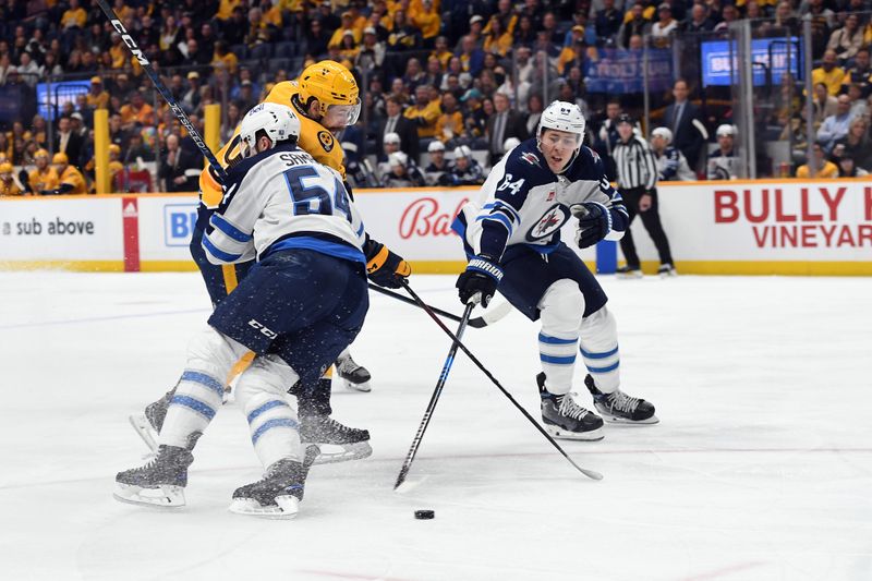 Apr 9, 2024; Nashville, Tennessee, USA; Nashville Predators left wing Filip Forsberg (9) is hit by Winnipeg Jets defenseman Dylan Samberg (54) as defenseman Logan Stanley (64) takes the puck during the first period at Bridgestone Arena. Mandatory Credit: Christopher Hanewinckel-USA TODAY Sports