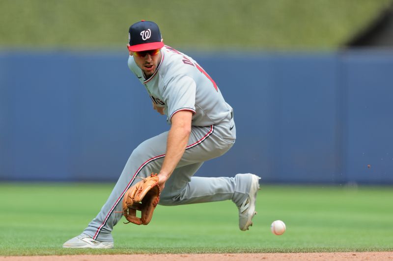 Apr 13, 2025; Miami, Florida, USA; Washington Nationals shortstop Paul DeJong (14) catches ground ball but cannot throw in time retire Miami Marlins third baseman Eric Wagaman (not pictured) during the fifth inning at loanDepot Park. Mandatory Credit: Sam Navarro-Imagn Images