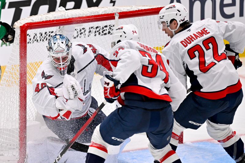 Oct 28, 2025; Dallas, Texas, USA; Washington Capitals goaltender Logan Thompson (48) makes a glove save on a Dallas Stars shot during the third period at the American Airlines Center. Mandatory Credit: Jerome Miron-Imagn Images