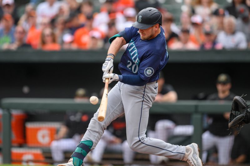 May 19, 2024; Baltimore, Maryland, USA; Seattle Mariners outfielder Luke Raley (20) hits a double during the second inning against the Baltimore Orioles at Oriole Park at Camden Yards. Mandatory Credit: Reggie Hildred-USA TODAY Sports