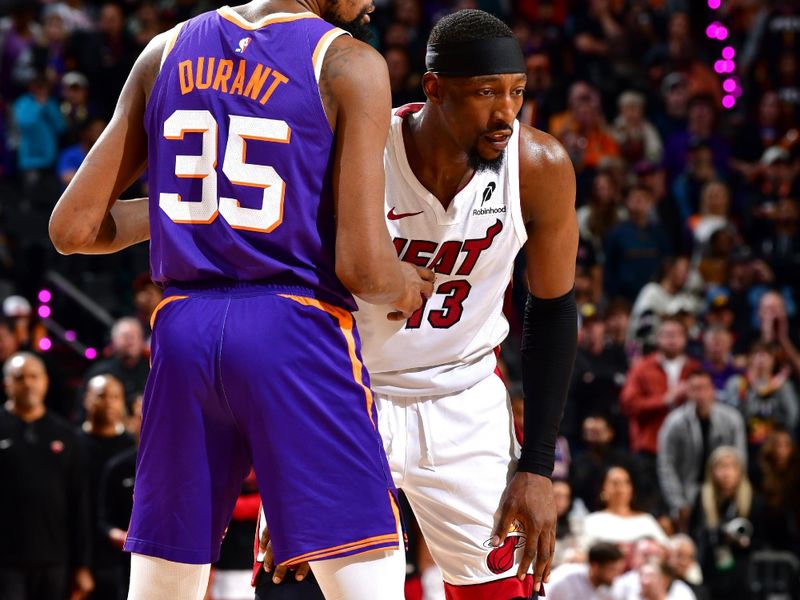 PHOENIX, AZ - NOVEMBER 6: Bam Adebayo #13 of the Miami Heat and Kevin Durant #35 of the Phoenix Suns look on during the game on November 6, 2024 at Footprint Center in Phoenix, Arizona. NOTE TO USER: User expressly acknowledges and agrees that, by downloading and or using this photograph, user is consenting to the terms and conditions of the Getty Images License Agreement. Mandatory Copyright Notice: Copyright 2024 NBAE (Photo by Barry Gossage/NBAE via Getty Images)