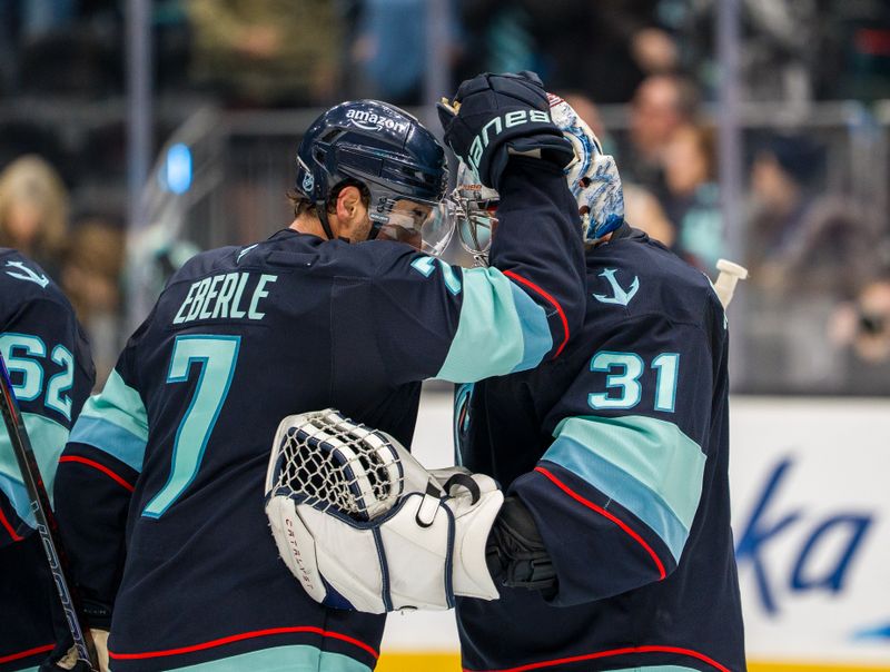 Jan 21, 2026; Seattle, Washington, USA; Seattle Kraken forward Jordan Eberle (7) and goalie Philipp Grubauer (31) celebrate after a game against the New York Islanders at Climate Pledge Arena. Mandatory Credit: Stephen Brashear-Imagn Images
