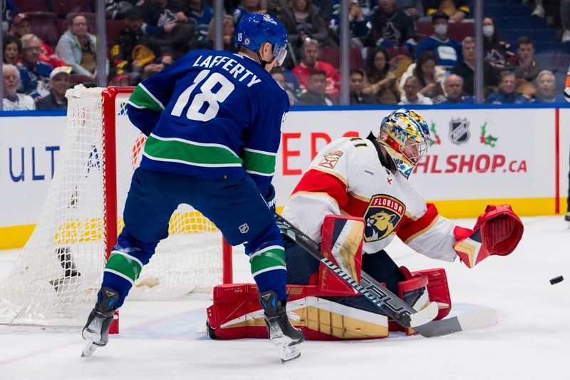 Dec 14, 2023; Vancouver, British Columbia, CAN; Florida Panthers goalie Anthony Stolarz (41) makes a save as Vancouver Canucks forward Sam Lafferty (18) watches the rebound in the third period at Rogers Arena. Vancouver won 4-0. Mandatory Credit: Bob Frid-USA TODAY Sports