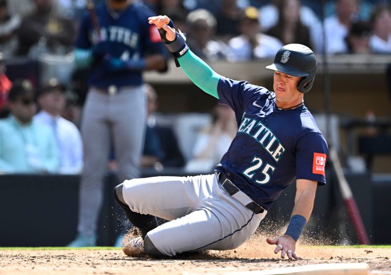 May 18, 2025; San Diego, California, USA; Seattle Mariners second baseman Dylan Moore (25) slides as he scores during the ninth inning against the San Diego Padres at Petco Park. Mandatory Credit: Denis Poroy-Imagn Images