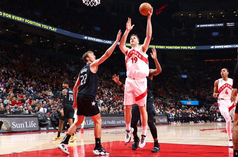 TORONTO, CANADA - FEBRUARY 14: Jakob Poeltl #19 of the Toronto Raptors drives to the basket during the game against the Orlando Magic on February 14, 2023 at the Scotiabank Arena in Toronto, Ontario, Canada.  NOTE TO USER: User expressly acknowledges and agrees that, by downloading and or using this Photograph, user is consenting to the terms and conditions of the Getty Images License Agreement.  Mandatory Copyright Notice: Copyright 2023 NBAE (Photo by Vaughn Ridley/NBAE via Getty Images)