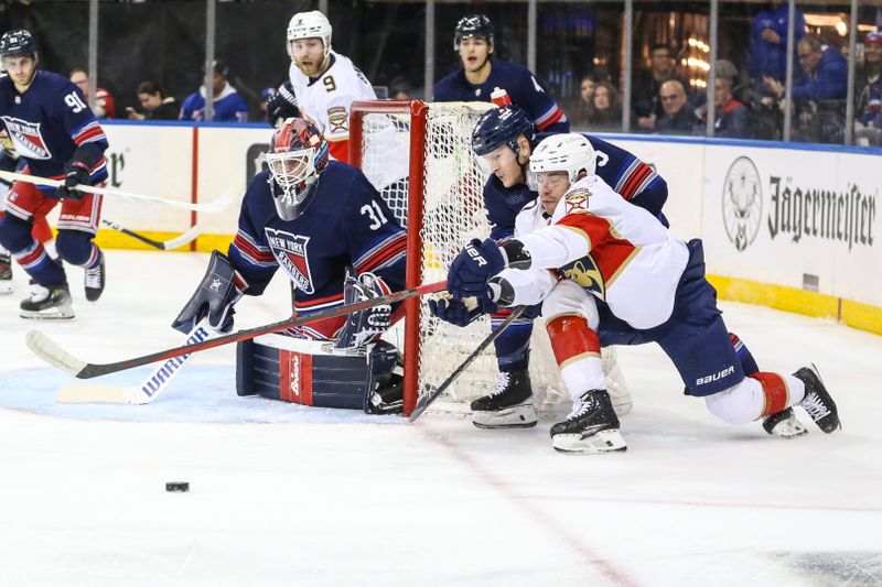 Mar 23, 2024; New York, New York, USA; New York Rangers defenseman Chad Ruhwedel (5) and Florida Panthers defenseman Dmitry Kulikov (7) battle for control of the puck in the first period at Madison Square Garden. Mandatory Credit: Wendell Cruz-USA TODAY Sports