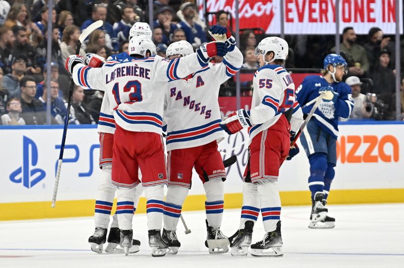 Mar 2, 2024; Toronto, Ontario, CAN;  New York Rangers forward Alexis Lafreniere (13) celebrates with team mates after scoring a goal against the Toronto Maple Leafs in the first period at Scotiabank Arena. Mandatory Credit: Dan Hamilton-USA TODAY Sports