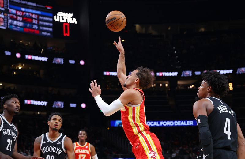 ATLANTA, GEORGIA - DECEMBER 06:  Trae Young #11 of the Atlanta Hawks attempts a shot against Dennis Smith Jr. #4 and Dorian Finney-Smith #28 during the first quarter at State Farm Arena on December 06, 2023 in Atlanta, Georgia.  NOTE TO USER: User expressly acknowledges and agrees that, by downloading and/or using this photograph, user is consenting to the terms and conditions of the Getty Images License Agreement.  (Photo by Kevin C. Cox/Getty Images)