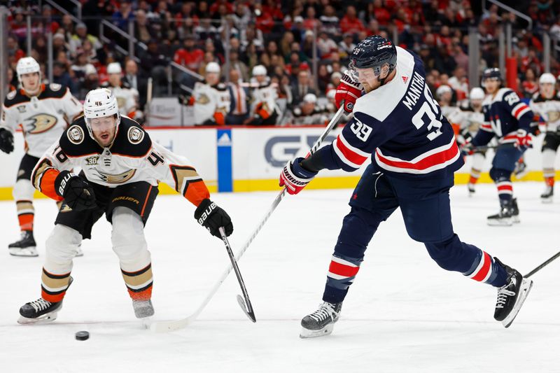 Jan 16, 2024; Washington, District of Columbia, USA; Washington Capitals right wing Anthony Mantha (39) shoots the puck as Anaheim Ducks defenseman Ilya Lyubushkin (46) defends in the third period at Capital One Arena. Mandatory Credit: Geoff Burke-USA TODAY Sports