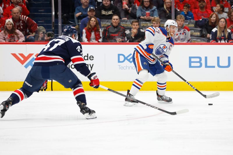 Nov 24, 2023; Washington, District of Columbia, USA; Edmonton Oilers center Connor McDavid (97) skates with the puck as Washington Capitals left wing Beck Malenstyn (47) chase in the second period at Capital One Arena. Mandatory Credit: Geoff Burke-USA TODAY Sports