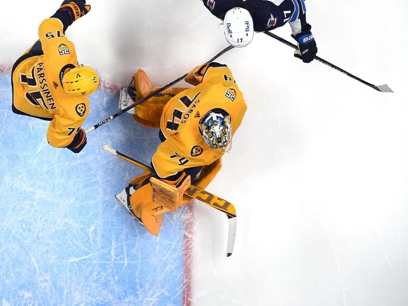 Nov 26, 2023; Nashville, Tennessee, USA; Winnipeg Jets defenseman Josh Morrissey (44) celebrates after scoring against Nashville Predators goaltender Juuse Saros (74) during the third period at Bridgestone Arena. Mandatory Credit: Christopher Hanewinckel-USA TODAY Sports