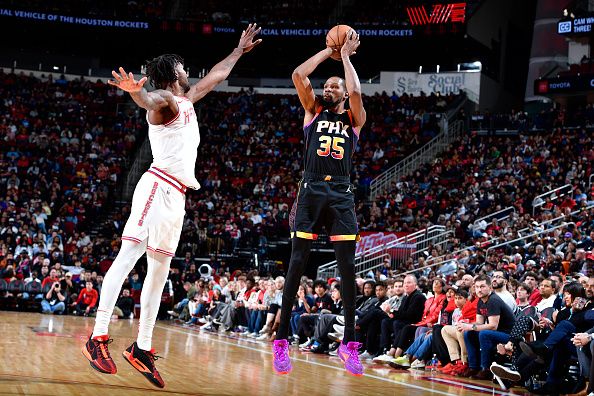 HOUSTON, TX - DECEMBER 27:   Kevin Durant #35 of the Phoenix Suns shoots a three point basket after the game against the Houston Rockets on December 27, 2023 at the Toyota Center in Houston, Texas. NOTE TO USER: User expressly acknowledges and agrees that, by downloading and or using this photograph, User is consenting to the terms and conditions of the Getty Images License Agreement. Mandatory Copyright Notice: Copyright 2023 NBAE (Photo by Logan Riely/NBAE via Getty Images)