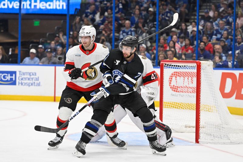 Mar 28, 2026; Tampa, Florida, USA; Tampa Bay Lightning center Anthony Cirelli (71) battles for the buck against Ottawa Senators center Lars Eller (89) during the third period at Benchmark International Arena. Mandatory Credit: Pablo Robles-Imagn Images