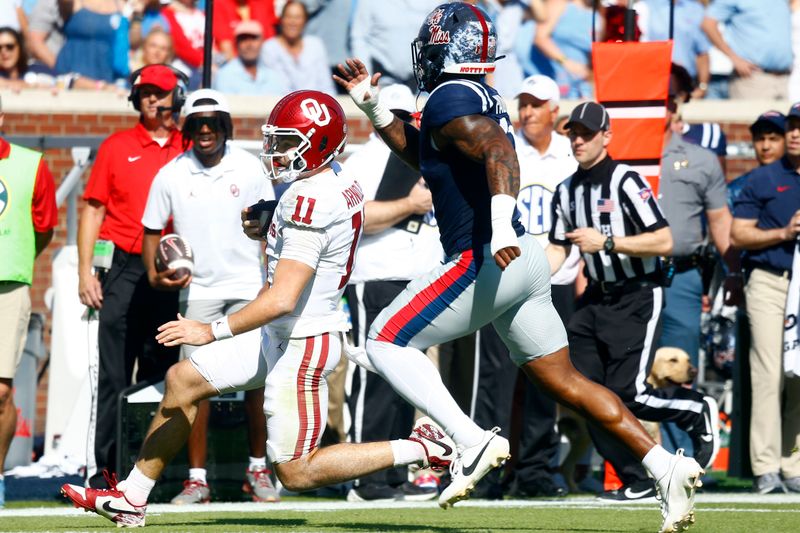 Oct 26, 2024; Oxford, Mississippi, USA; Oklahoma Sooners quarterback Jackson Arnold (11) runs the ball for a first down as Mississippi Rebels linebacker Chris Paul Jr. (11) pursues during the first half at Vaught-Hemingway Stadium. Mandatory Credit: Petre Thomas-Imagn Images