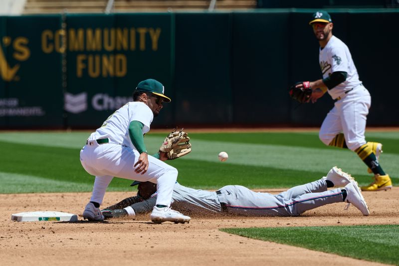 May 5, 2024; Oakland, California, USA; Oakland Athletics infielder Darell Hernaiz (2) tags out Miami Marlins outfielder Nick Gordon (1) at second base on a stolen base attempt during the third inning at Oakland-Alameda County Coliseum. Mandatory Credit: Robert Edwards-USA TODAY Sports