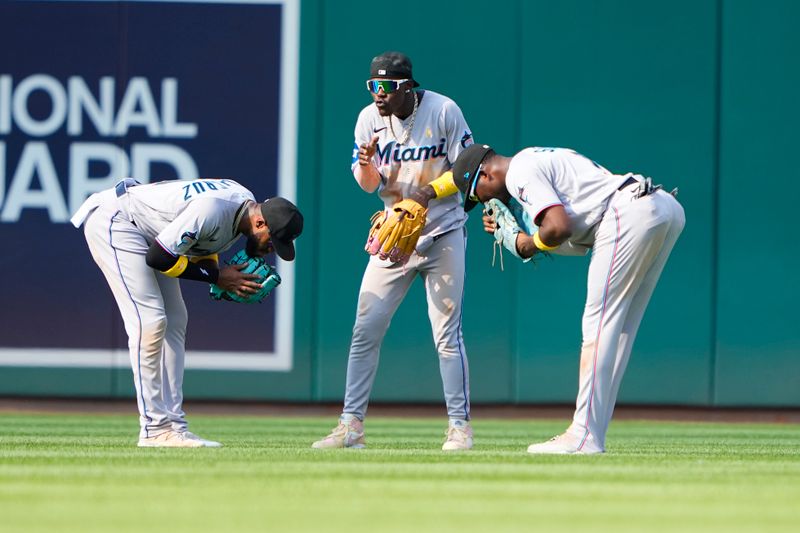 Sep 3, 2023; Washington, District of Columbia, USA;  Miami Marlins left fielder Bryan De La Cruz (14) and center fielder Jazz Chisholm Jr. (2) and right fielder Jesus Sanchez (7) celebrate the victory after the game against the Washington Nationals at Nationals Park. Mandatory Credit: Gregory Fisher-USA TODAY Sports