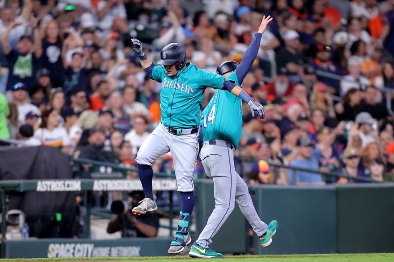 May 4, 2024; Houston, Texas, USA; Seattle Mariners third baseman Luis Urias (16) celebrates with Seattle Mariners third base coach Manny Acta (14) after hitting a solo home run to center field against the Houston Astros during the fifth inning at Minute Maid Park. Mandatory Credit: Erik Williams-USA TODAY Sports