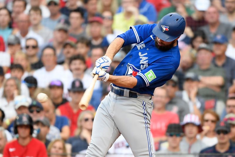 Aug 5, 2023; Boston, Massachusetts, USA;  Toronto Blue Jays designated hitter Brandon Belt (13) hits an RBI single during the sixth inning against the Boston Red Sox at Fenway Park. Mandatory Credit: Bob DeChiara-USA TODAY Sports