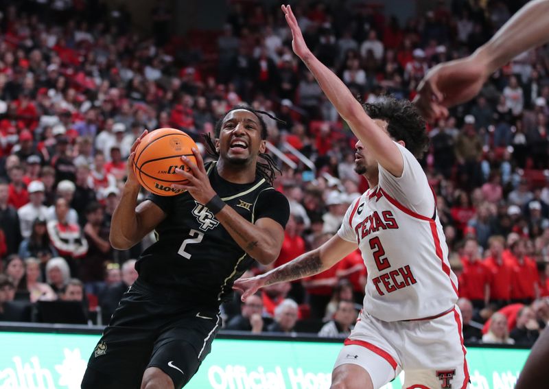 Feb 10, 2024; Lubbock, Texas, USA;  Central Florida Knights guard Shemarri Allen (2) drives to the lane against Texas Tech Red Raiders guard Pop Isaacs (2) in the first half United Supermarkets Arena. Mandatory Credit: Michael C. Johnson-USA TODAY Sports