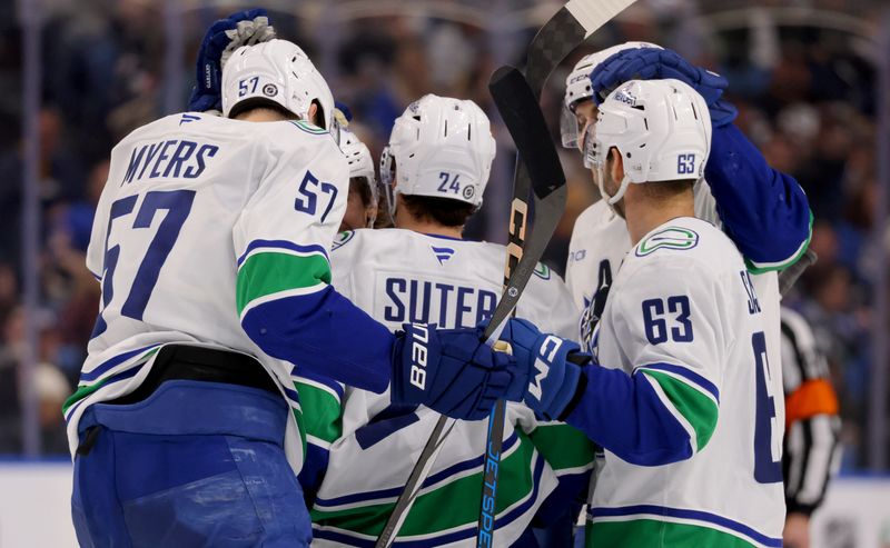 Nov 29, 2024; Buffalo, New York, USA;  Vancouver Canucks center Pius Suter (24) celebrates his goal with teammates during the third period against the Buffalo Sabres at KeyBank Center. Mandatory Credit: Timothy T. Ludwig-Imagn Images