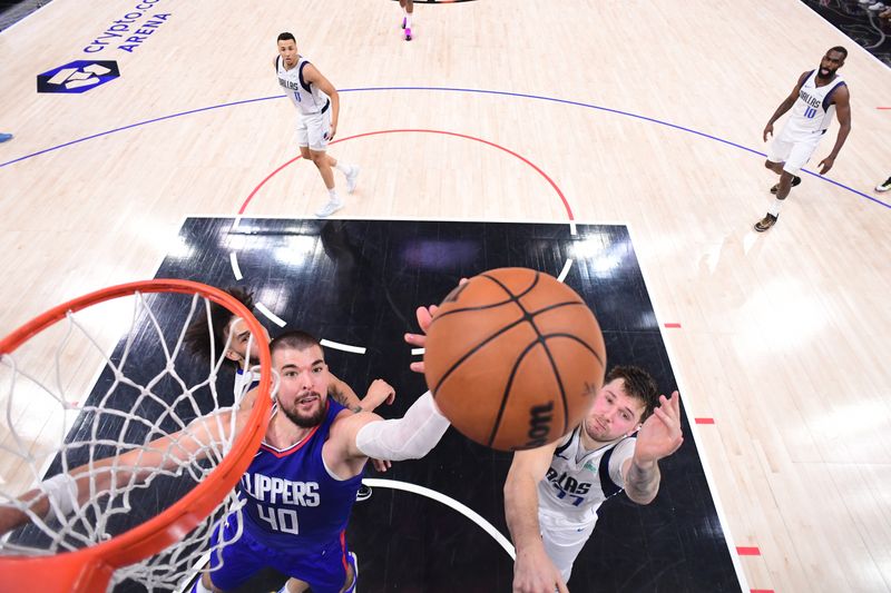 LOS ANGELES, CA - APRIL 21:  Ivica Zubac #40 of the LA Clippers grabs a rebound during the game against the Dallas Mavericks during Round 1 Game 1 of the 2024 NBA Playoffs on April 21, 2024 at Crypto.Com Arena in Los Angeles, California. NOTE TO USER: User expressly acknowledges and agrees that, by downloading and/or using this Photograph, user is consenting to the terms and conditions of the Getty Images License Agreement. Mandatory Copyright Notice: Copyright 2024 NBAE (Photo by Adam Pantozzi/NBAE via Getty Images)