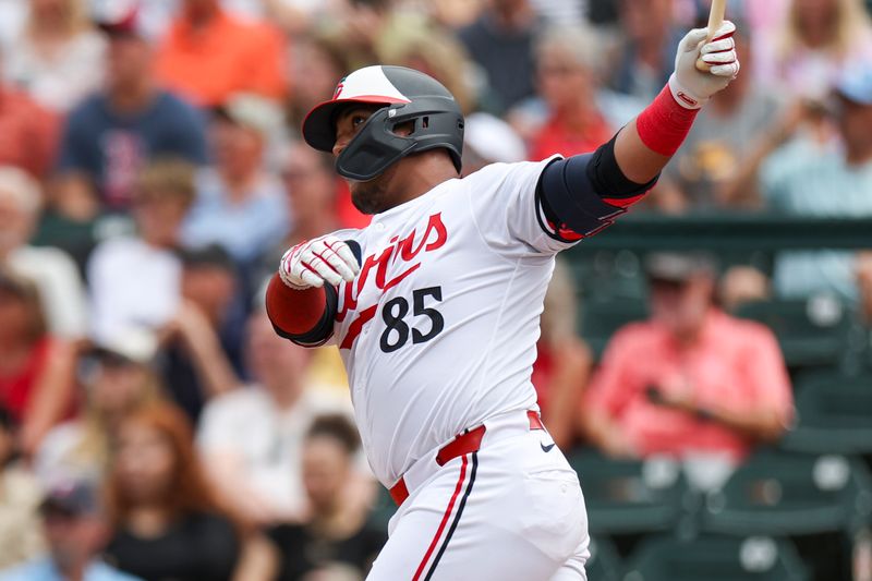 Mar 6, 2024; Fort Myers, Florida, USA;  Minnesota Twins catcher Jair Camargo (85) hits a two-run home run against the Boston Red Sox in the fourth inning at Hammond Stadium. Mandatory Credit: Nathan Ray Seebeck-USA TODAY Sports