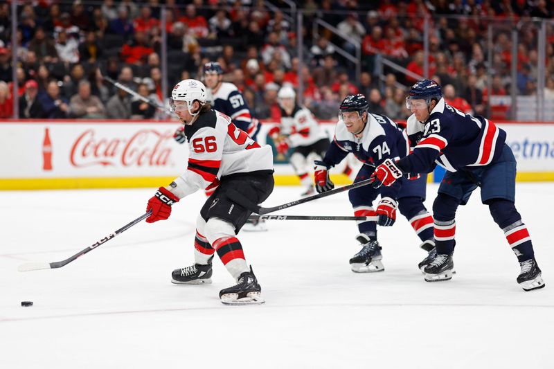 Feb 20, 2024; Washington, District of Columbia, USA; New Jersey Devils left wing Erik Haula (56) scores a goal as Washington Capitals defenseman John Carlson (74) and Capitals center Michael Sgarbossa (23) chase in the third period at Capital One Arena. Mandatory Credit: Geoff Burke-USA TODAY Sports