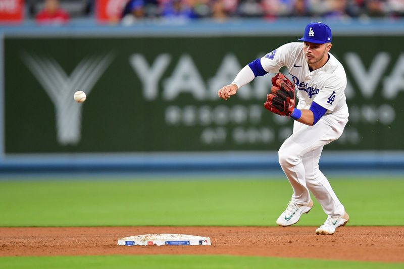 May 4, 2024; Los Angeles, California, USA; Los Angeles Dodgers second baseman Gavin Lux (9) fields the ground ball of Atlanta Braves shortstop Orlando Arcia (11) during the seventh inning at Dodger Stadium. Mandatory Credit: Gary A. Vasquez-USA TODAY Sports