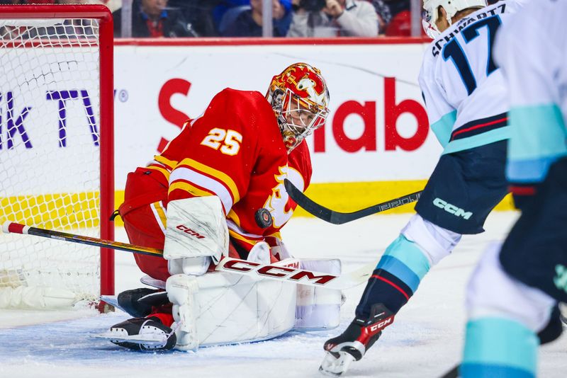 Mar 4, 2024; Calgary, Alberta, CAN; Calgary Flames goaltender Jacob Markstrom (25) makes a save against Seattle Kraken center Jaden Schwartz (17) during the first period at Scotiabank Saddledome. Mandatory Credit: Sergei Belski-USA TODAY Sports