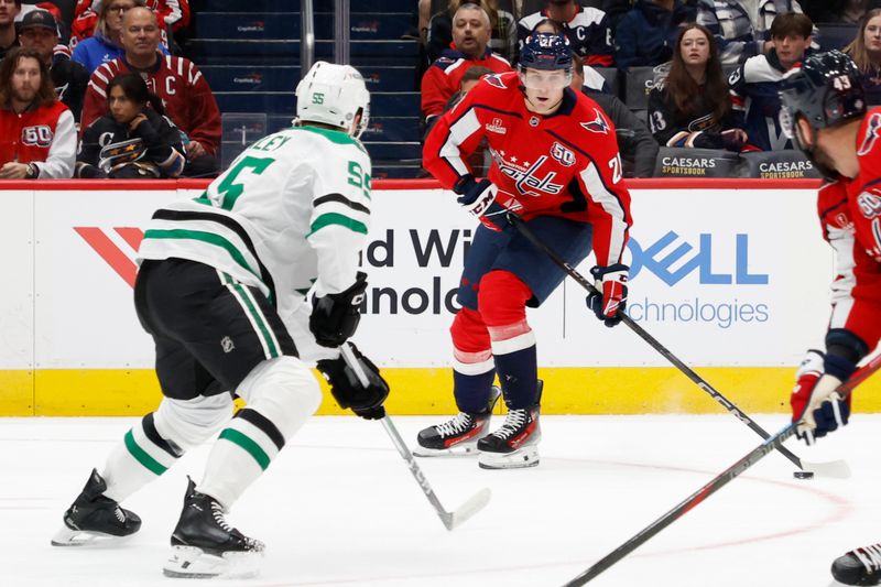 Oct 17, 2024; Washington, District of Columbia, USA; Washington Capitals center Aliaksei Protas (21) prepares to shoot the puck as Dallas Stars defenseman Thomas Harley (55) defends in the first period at Capital One Arena. Mandatory Credit: Geoff Burke-Imagn Images