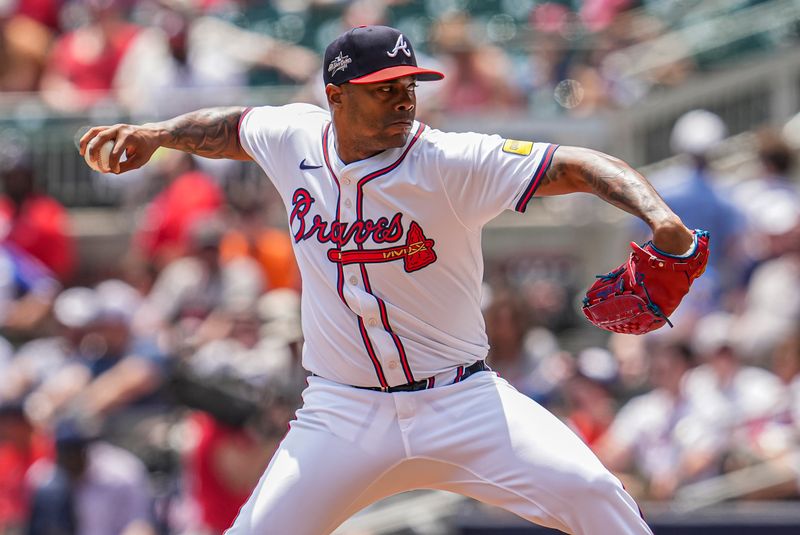 May 15, 2025; Cumberland, Georgia, USA; Atlanta Braves pitcher Raisel Iglesias (26) pitches against the Washington Nationals during the ninth inning at Truist Park. Mandatory Credit: Dale Zanine-Imagn Images