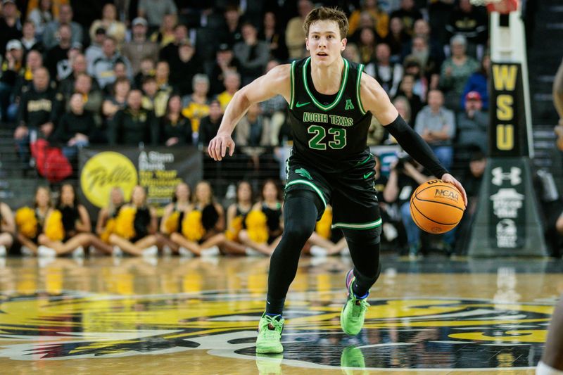 Jan 4, 2024; Wichita, Kansas, USA; North Texas Mean Green guard Matthew Stone (23) brings the ball up court during the second half against the Wichita State Shockers at Charles Koch Arena. Mandatory Credit: William Purnell-USA TODAY Sports