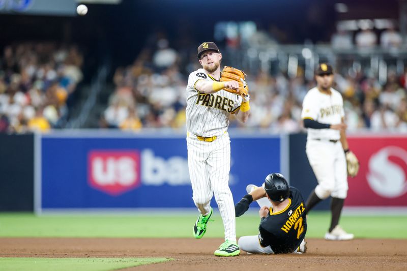 May 31, 2025; San Diego, California, USA; San Diego Padres second baseman Jake Cronenworth (9) throws to first base to complete a double play during the seventh inning against the Pittsburgh Pirates at Petco Park. Mandatory Credit: David Frerker-Imagn Images