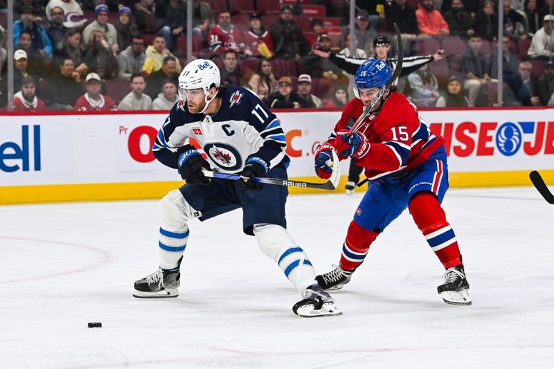 Oct 28, 2023; Montreal, Quebec, CAN; Montreal Canadiens center Alex Newhook (15) attempts to defend the puck against Winnipeg Jets center Adam Lowry (17) during the first period at Bell Centre. Mandatory Credit: David Kirouac-USA TODAY Sports