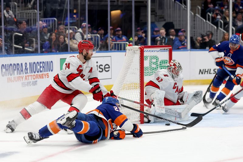 Jan 25, 2025; Elmont, New York, USA; Carolina Hurricanes goaltender Pyotr Kochetkov (52) makes a save against New York Islanders center Kyle Palmieri (21) during the third period at UBS Arena. Mandatory Credit: Brad Penner-Imagn Images